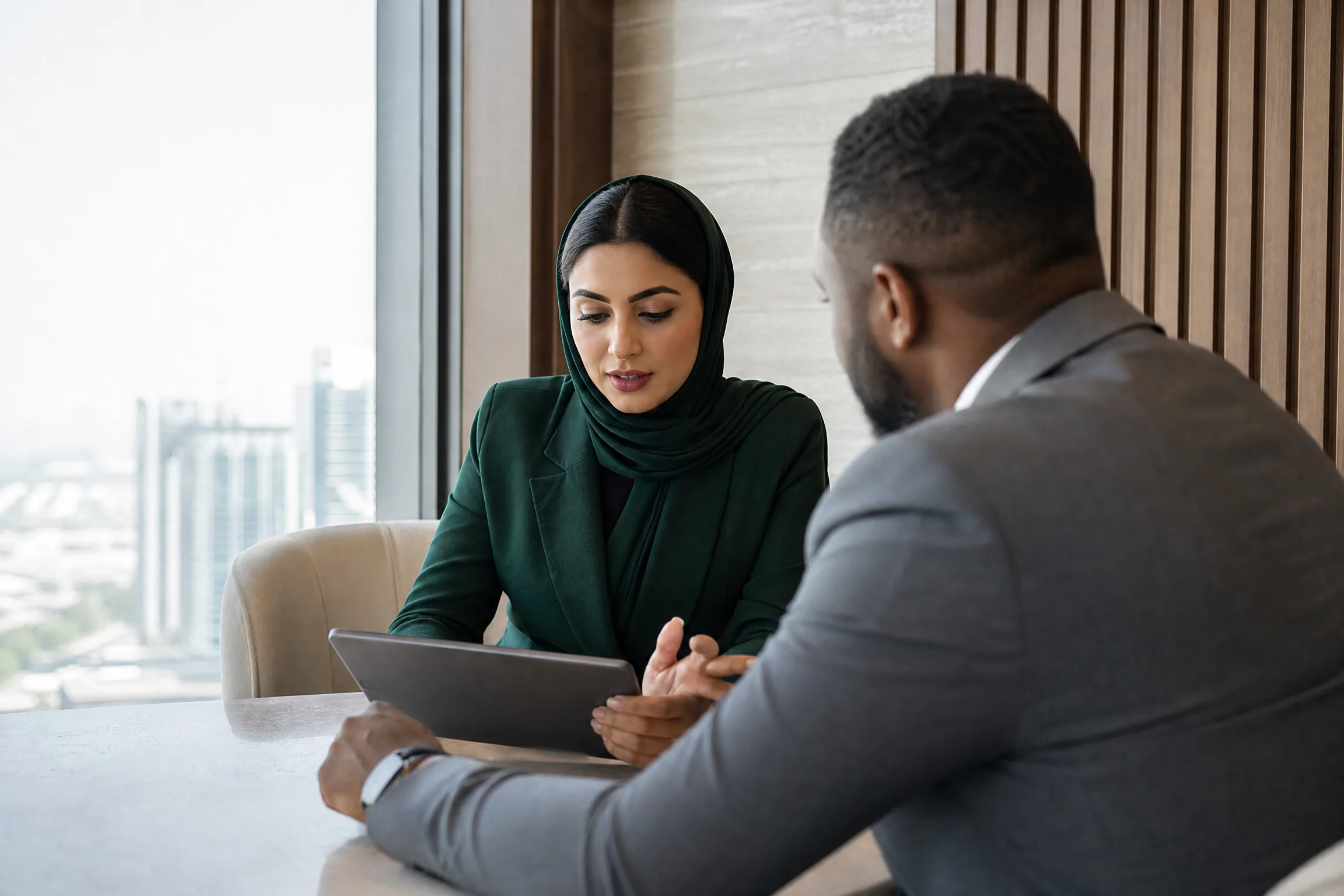 Corporate acquisition consultation in a modern office setting.